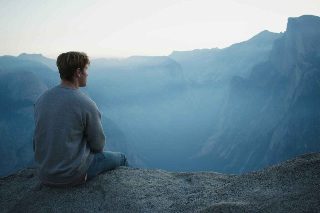 man looking at mountains